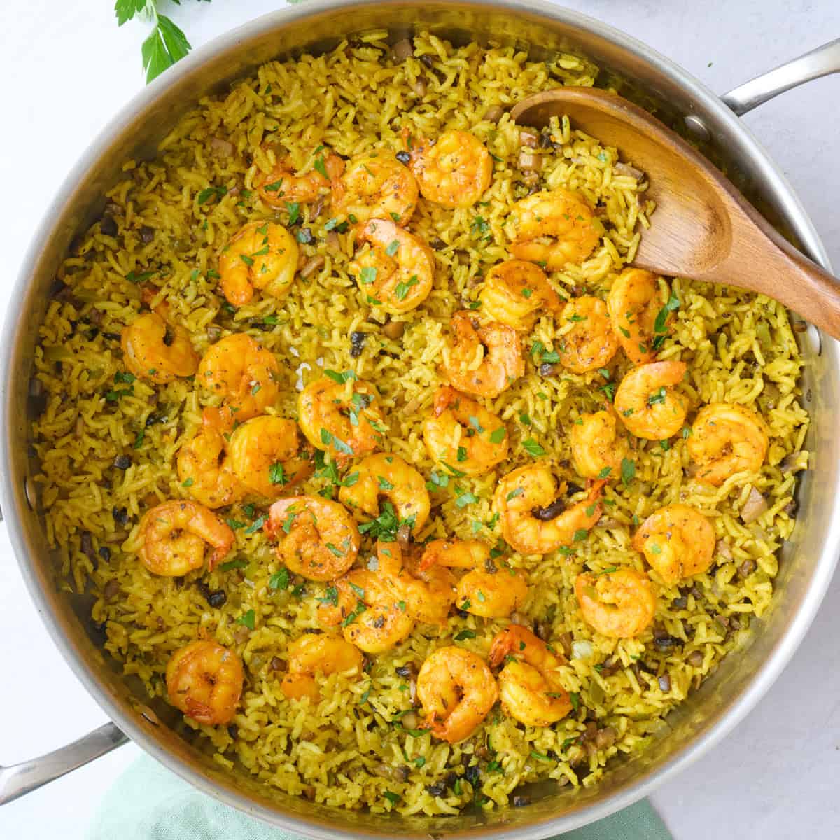 Shrimp and rice in the pot after fluffing rice, garnished with chopped parsley.