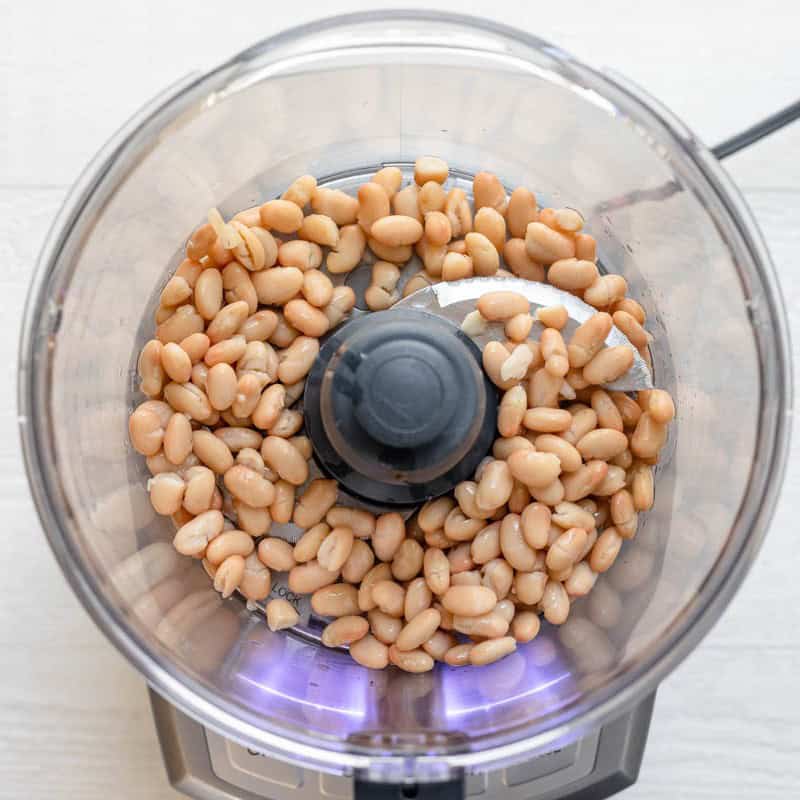 Place beans into food processor.