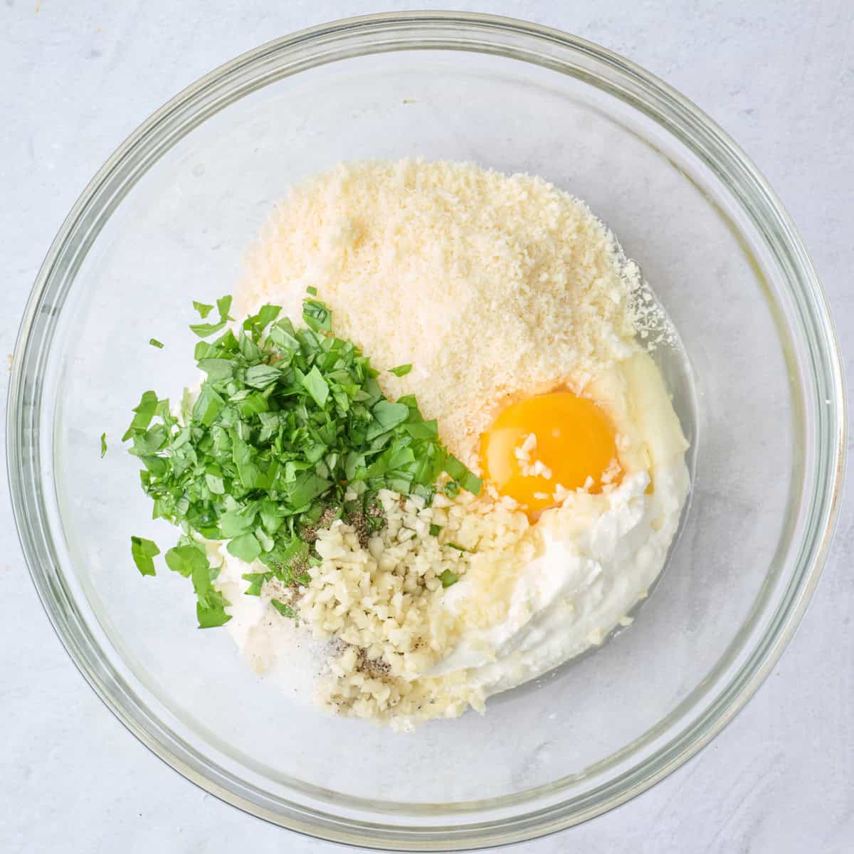Ricotta, egg, parmesan, basil, garlic salt and pepper before combined.