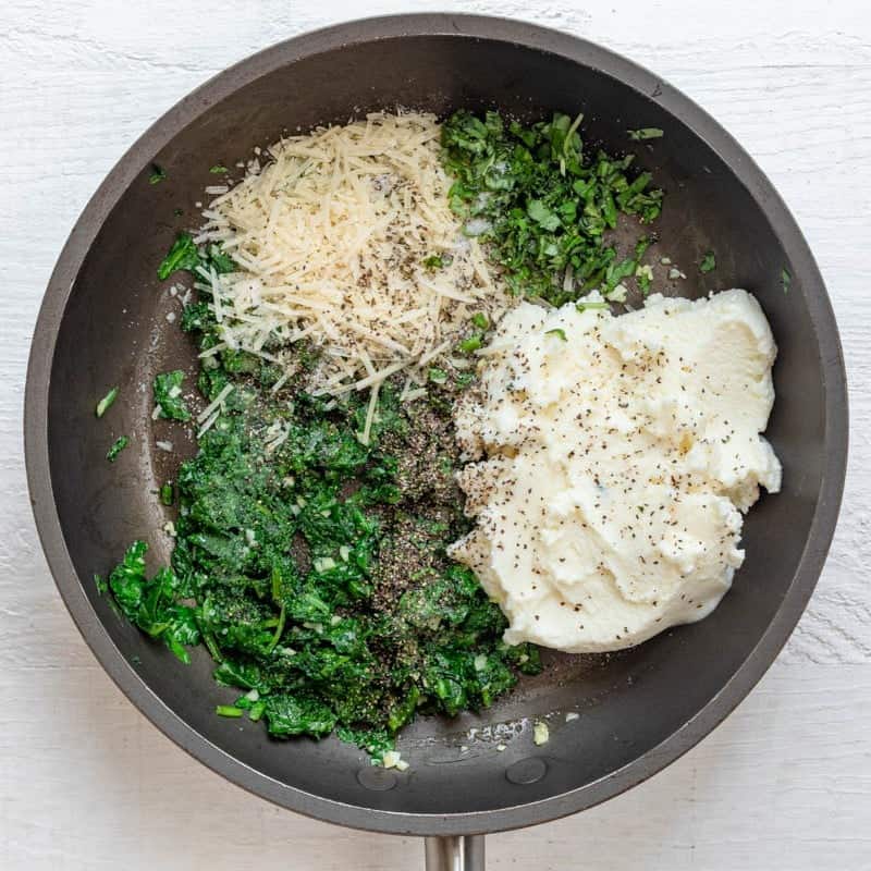 Once the spinach and garlic are cooked, the rest of the zucchini ravioli filling ingredients added to the skillet.