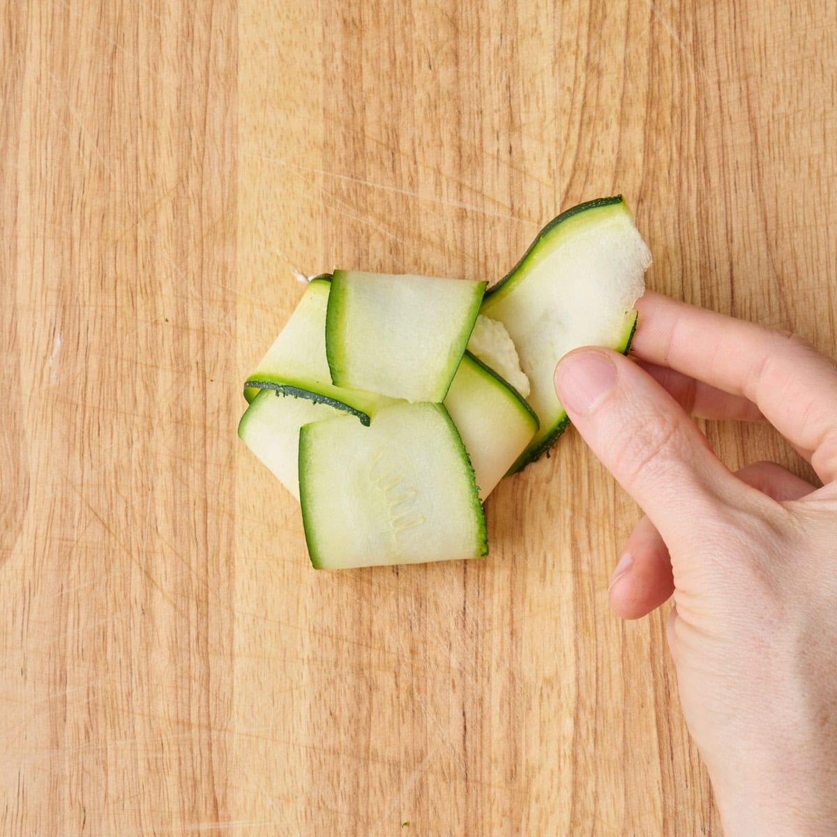 Folding in the final piece of zucchini towards the middle.