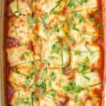 Zucchini ravioli in the baking dish garnished with basil.