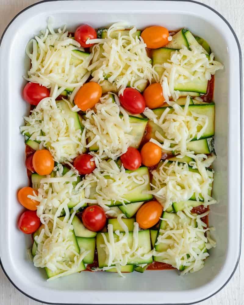 Cheese and tomatoes added on top of the zucchini ravioli.
