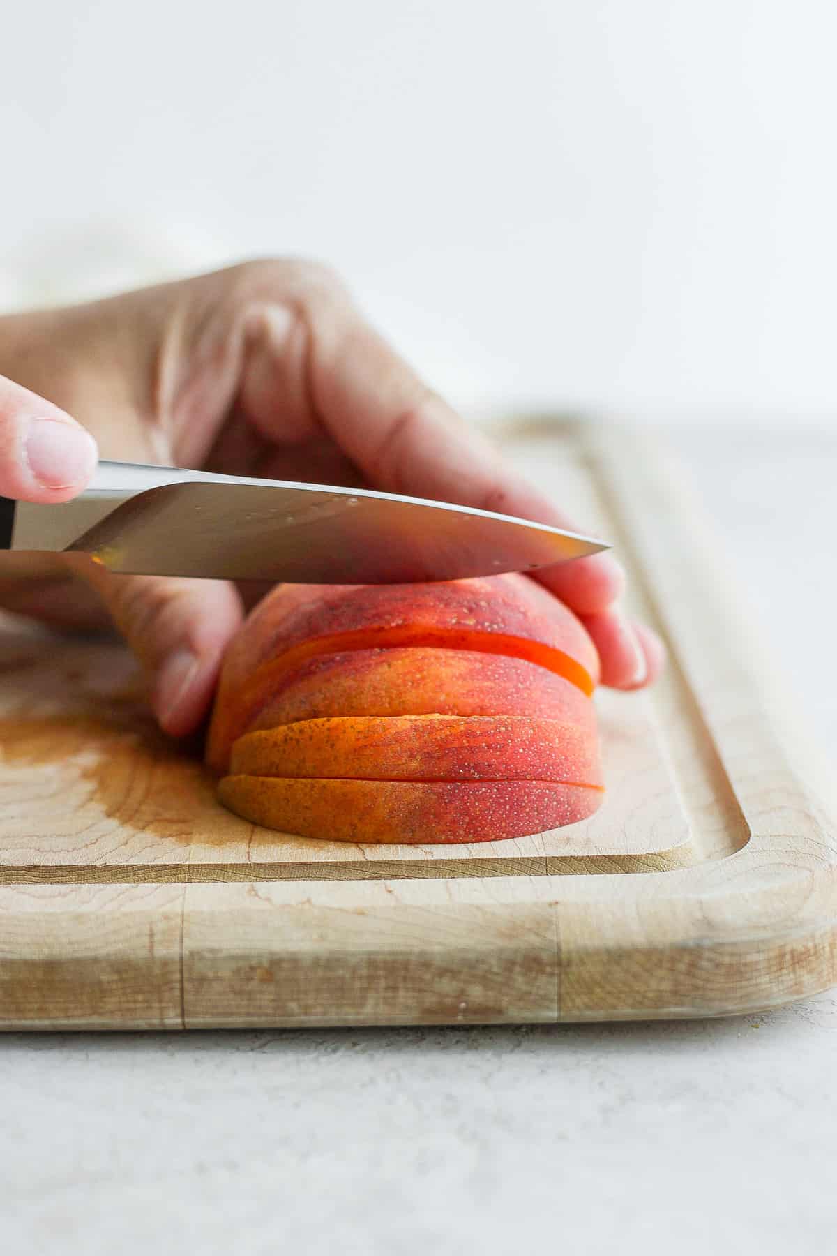 How to slice peach after it's cut in half