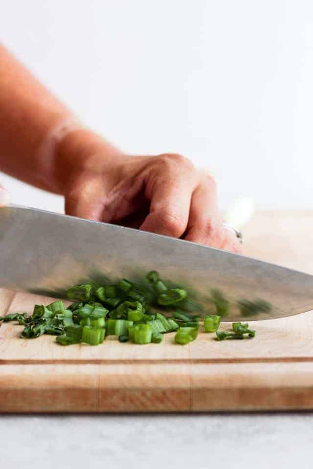 Chopping green onions on cutting board
