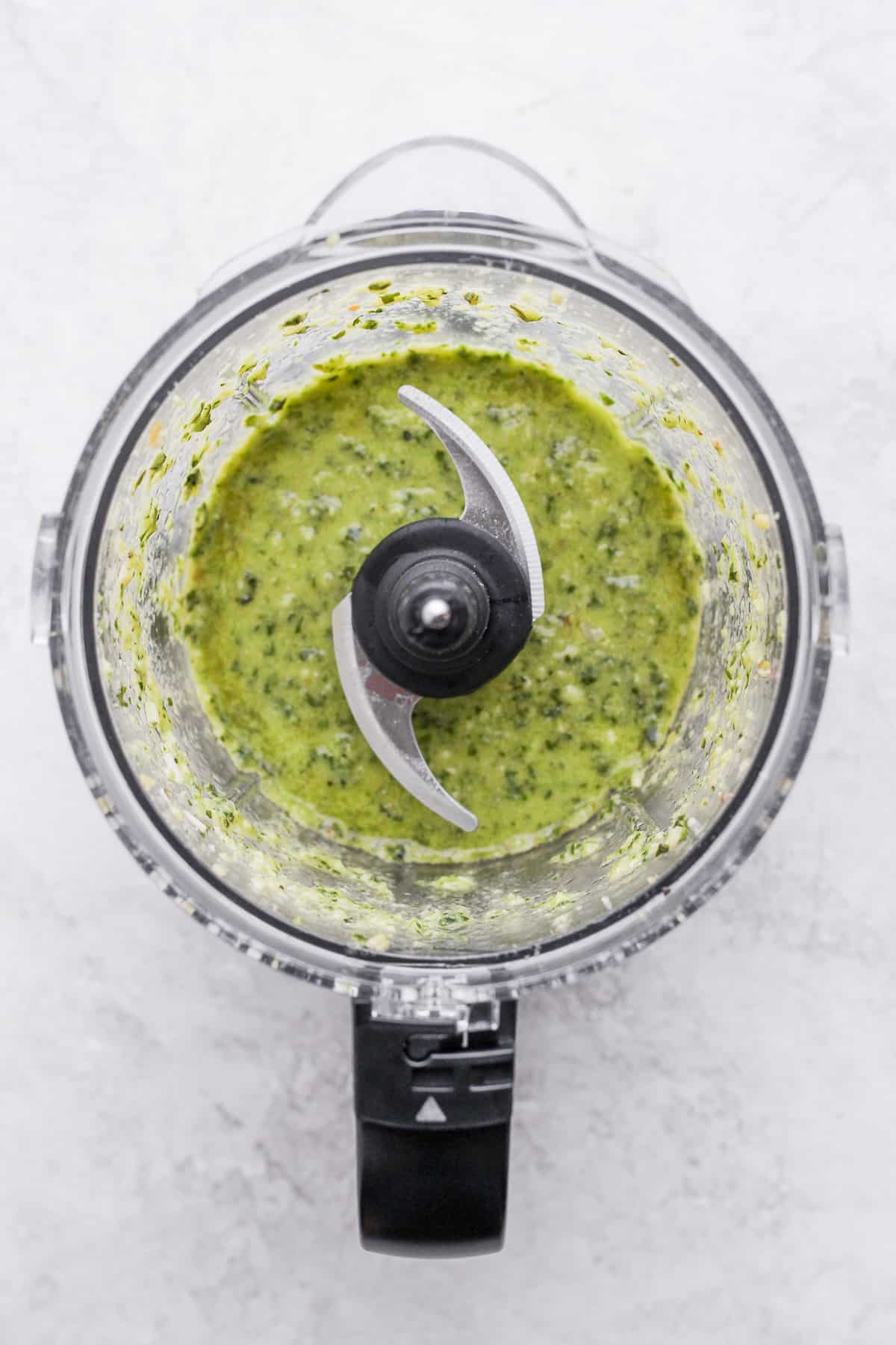 Easy Pesto in the KitchenAid 3.5 cup food processor. We call it a  “ChopChop”. We use it everyday at Sweet Gourmet and in our homes. Just put  2 cups