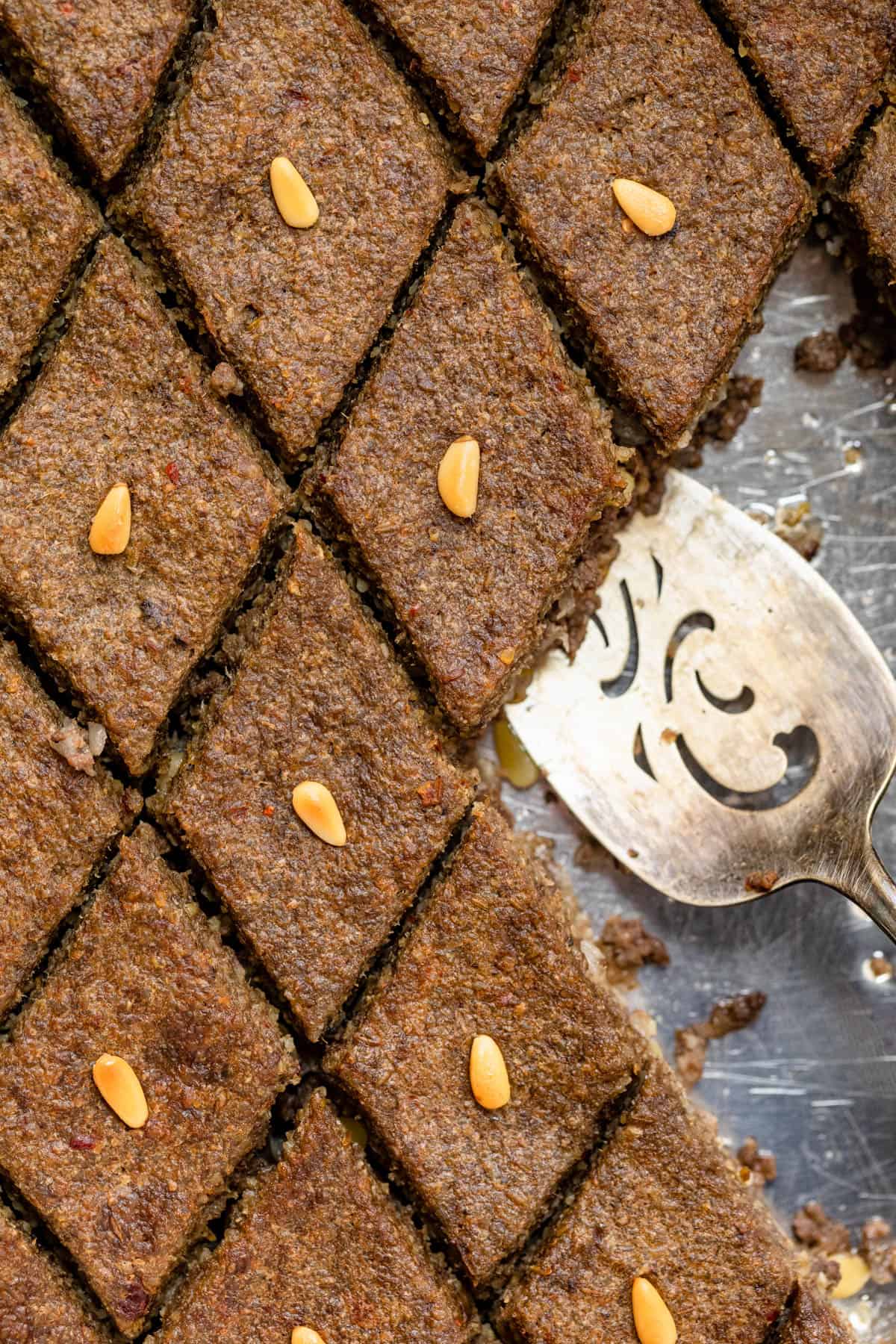 Close up shot of the kibbeh with spatula for serving
