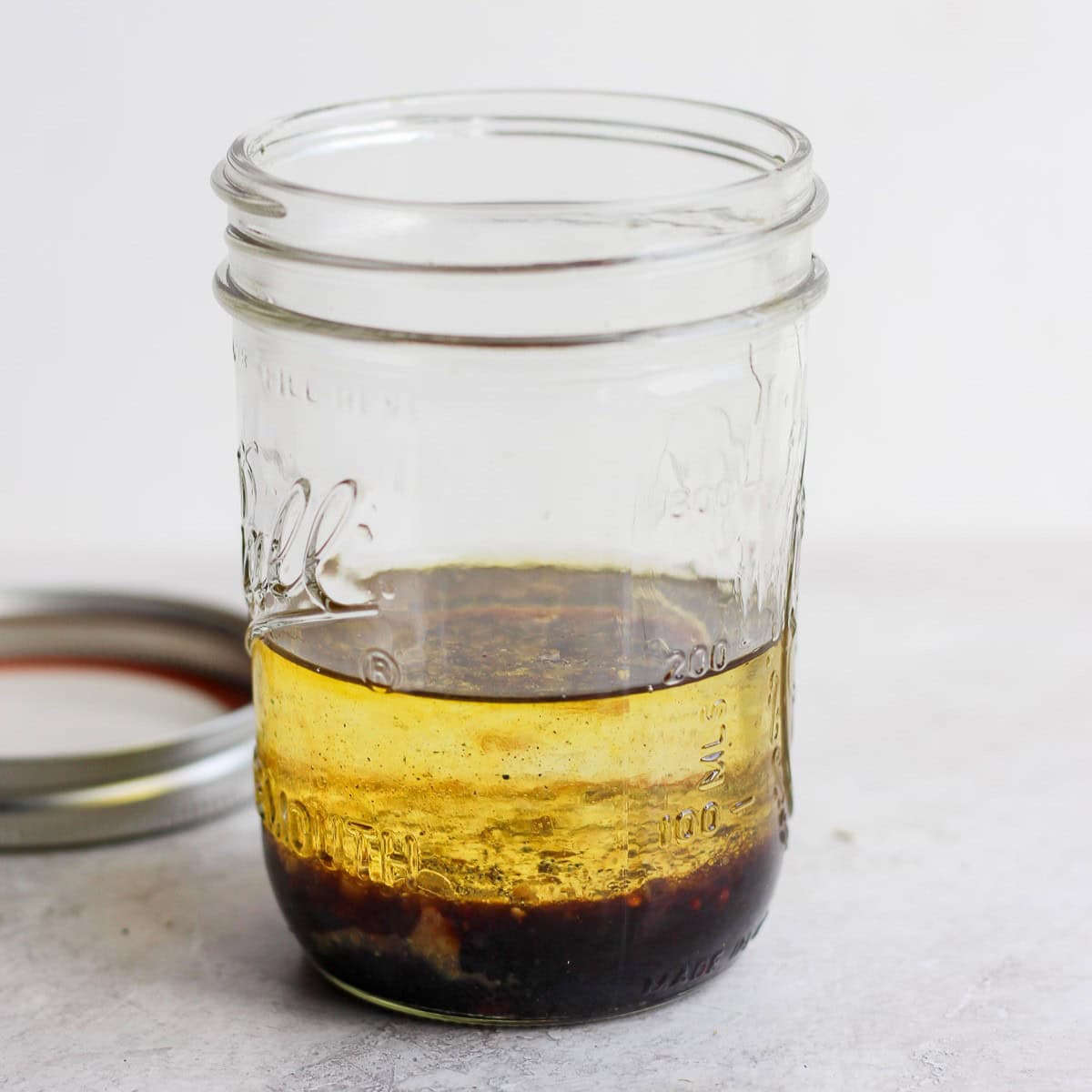 Broken vinaigrette ingredients in a jar before shaking.
