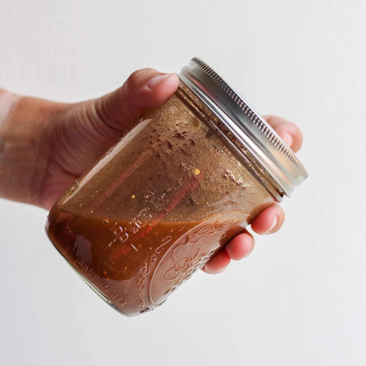 Shaking the ingredients in the jar.