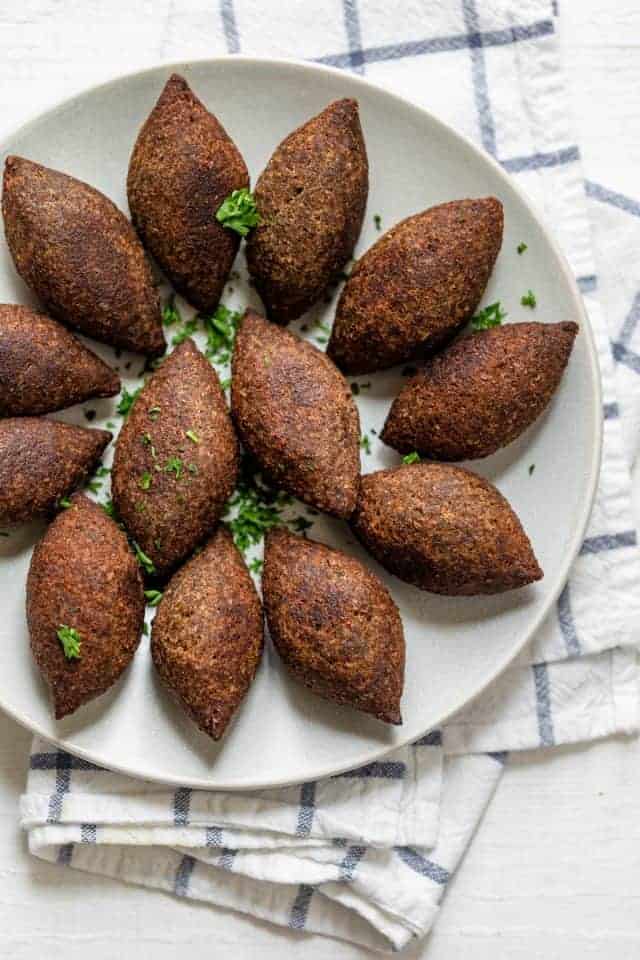 Kibbeh balls after fried on a white plate