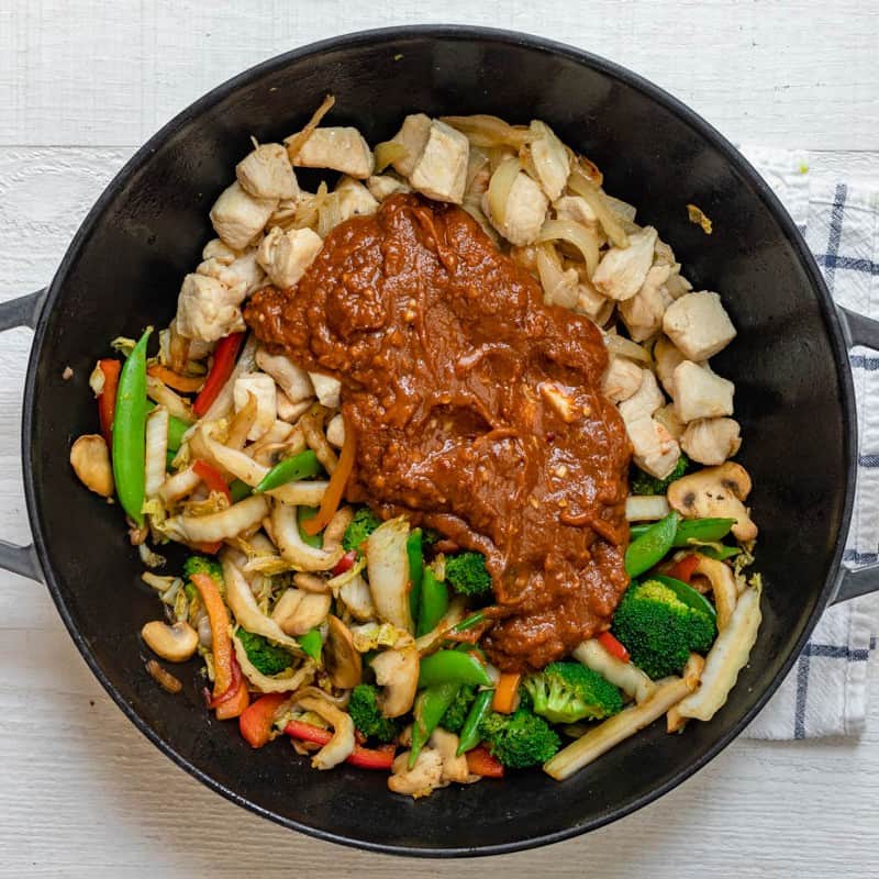 Sauce poured on top of the chicken and vegetables.