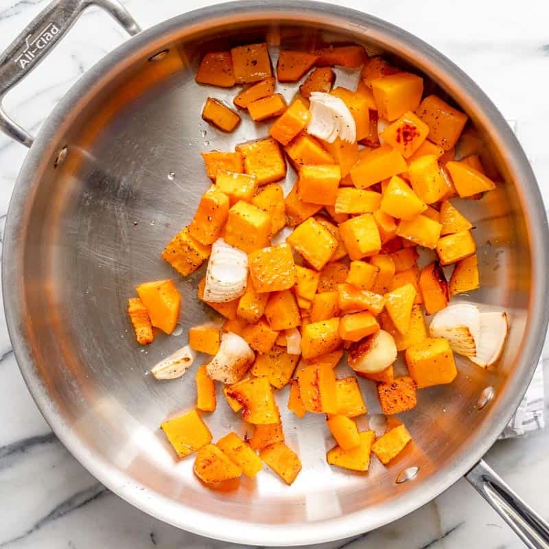 Roasted squash transferred into a pan.