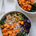 2 fall grain bowls made with butternut squash, kale, farro, beets, feta and pistachios
