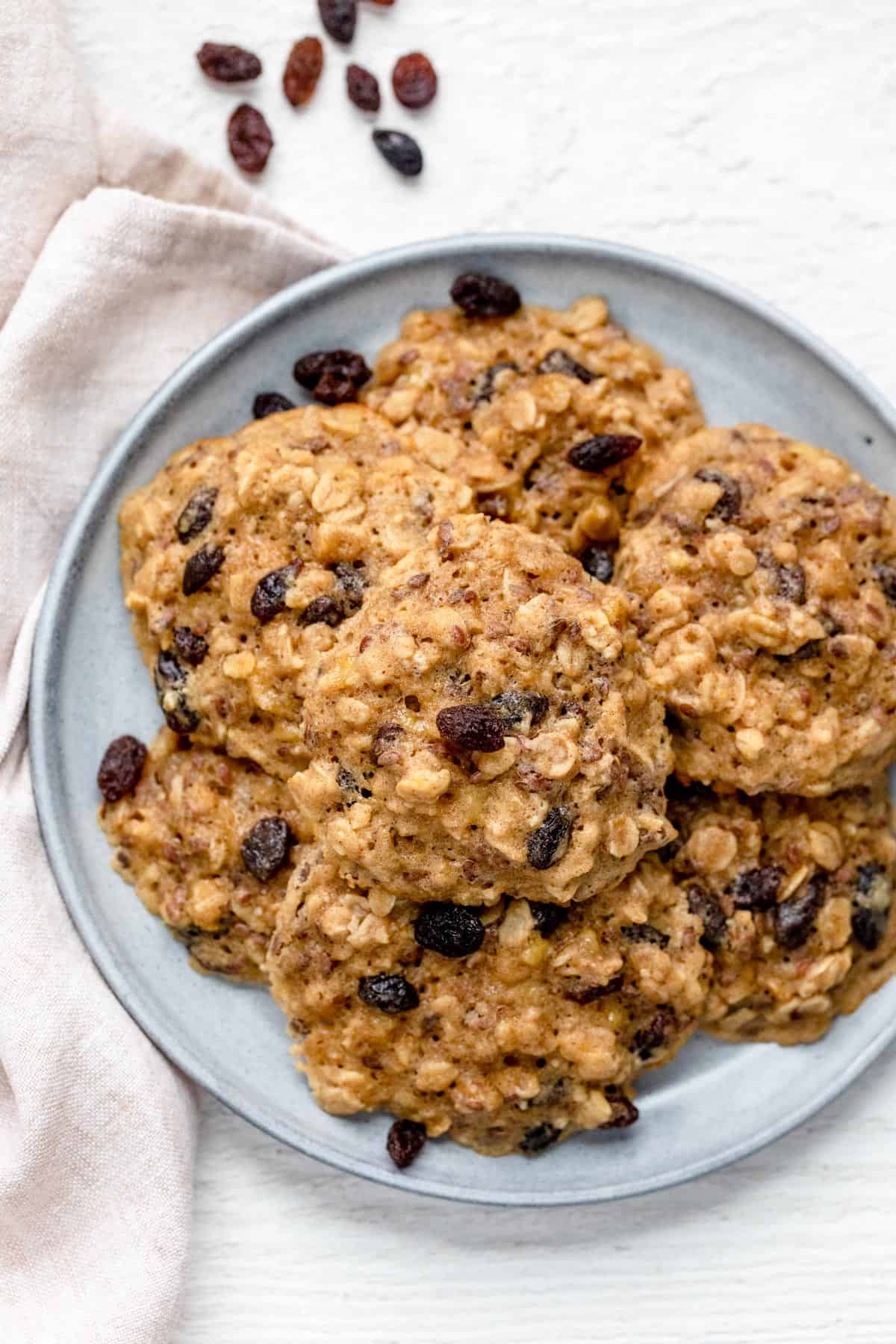 Oatmeal breakfast cookies on a plate with raisins on the side