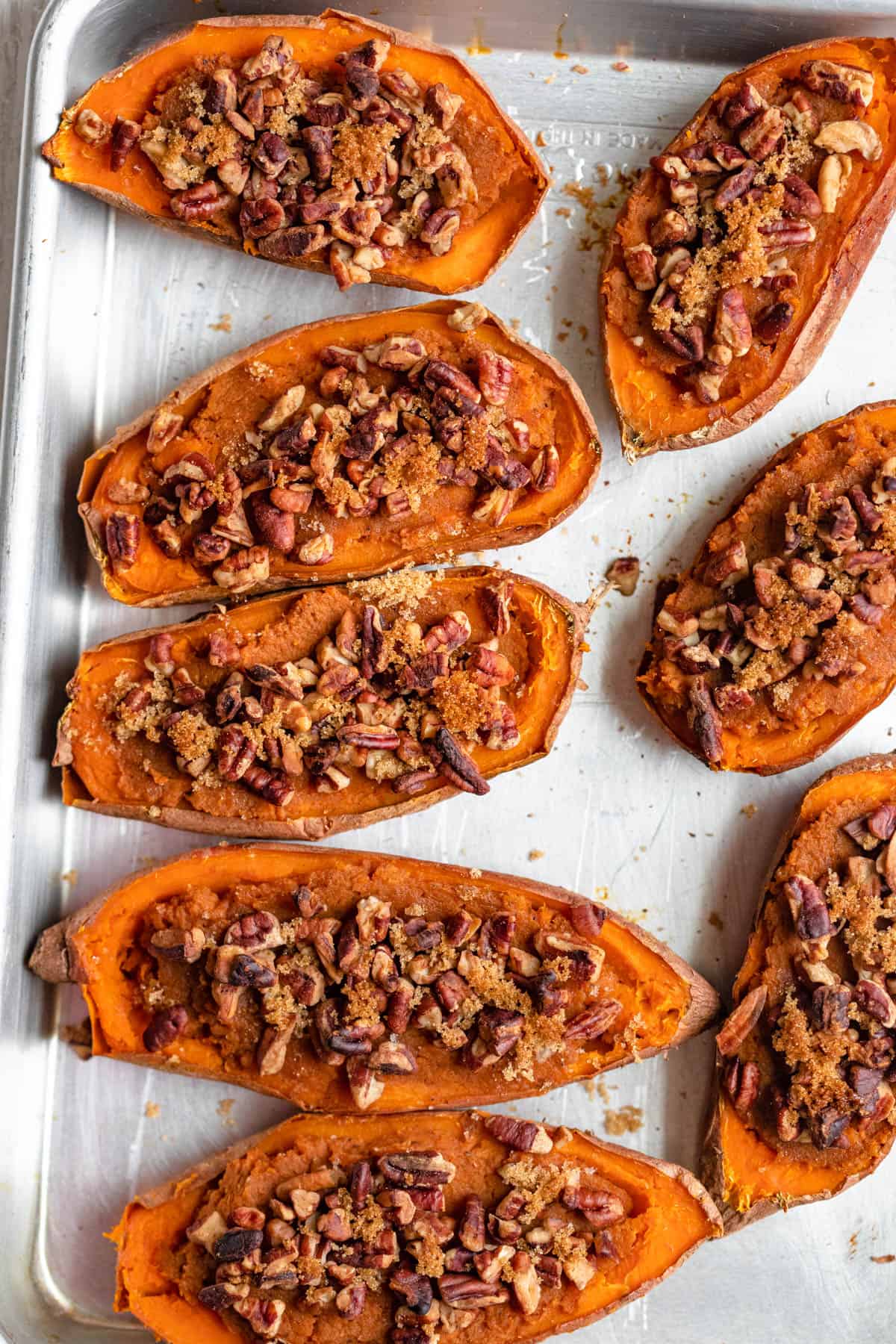 Twice baked sweet potatoes on a baking dish with parchment paper after baking
