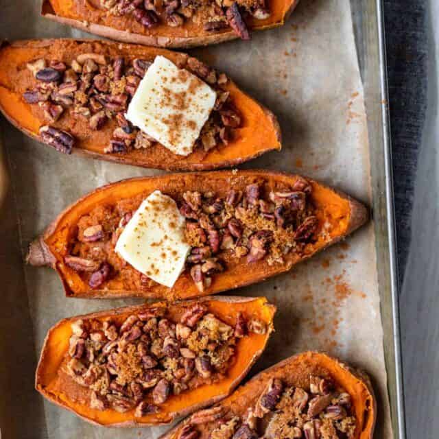 Small baking dish with four halves of sweet potatoes - two topped with dab of butter