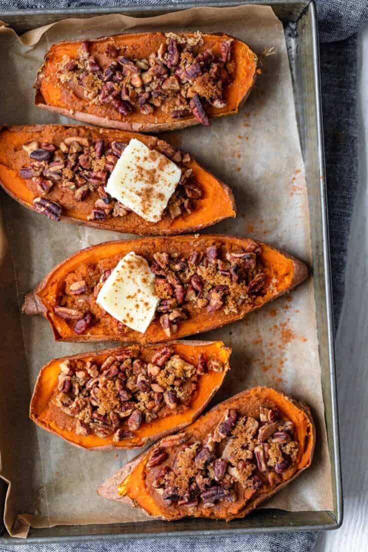 Small baking dish with four halves of sweet potatoes - two topped with dab of butter