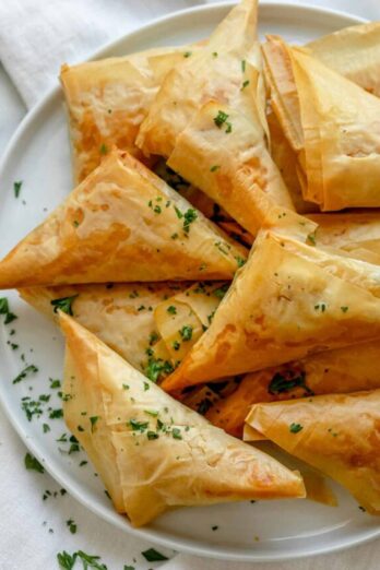 Spanakopita triangles after baking on a plate