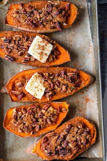 Small baking dish with four halves of sweet potatoes - two topped with dab of butter