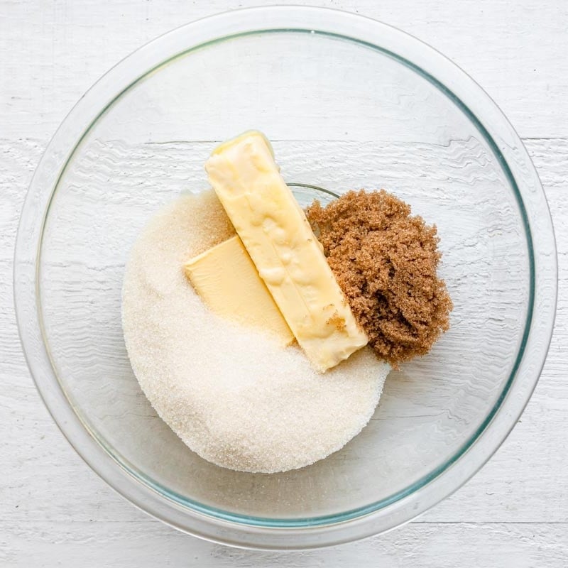 Butter and sugars in a bowl before mixing.