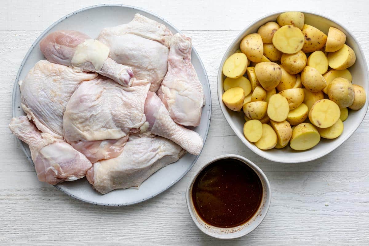 Ingredients to make the recipe: chicken, potatoes and the sauce mixture in a bowl