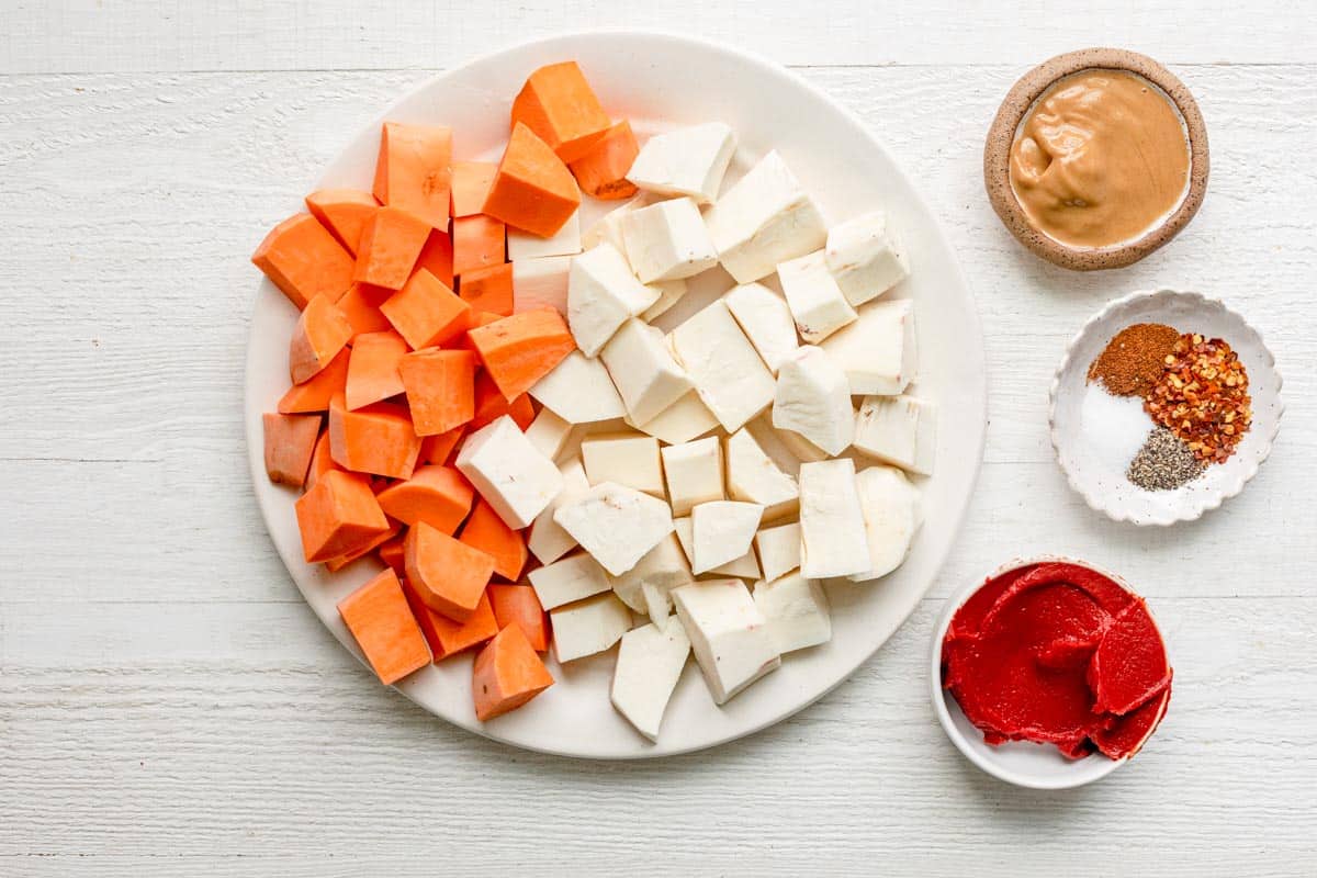 Plate of chopped sweet potatoes and chopped cassava with the spices, tomato paste and peanut butter