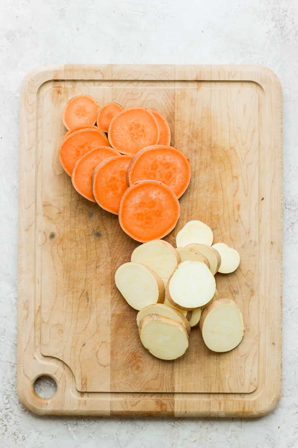 Cutting board with cut sweet potatoes and yams