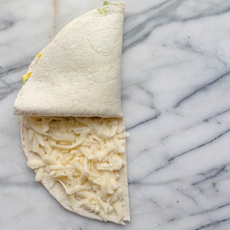 Egg and avocado sections folded on top of salsa.