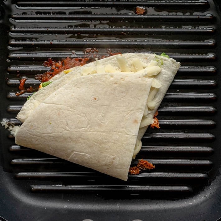 Tortilla wrap on griddle before cooked.