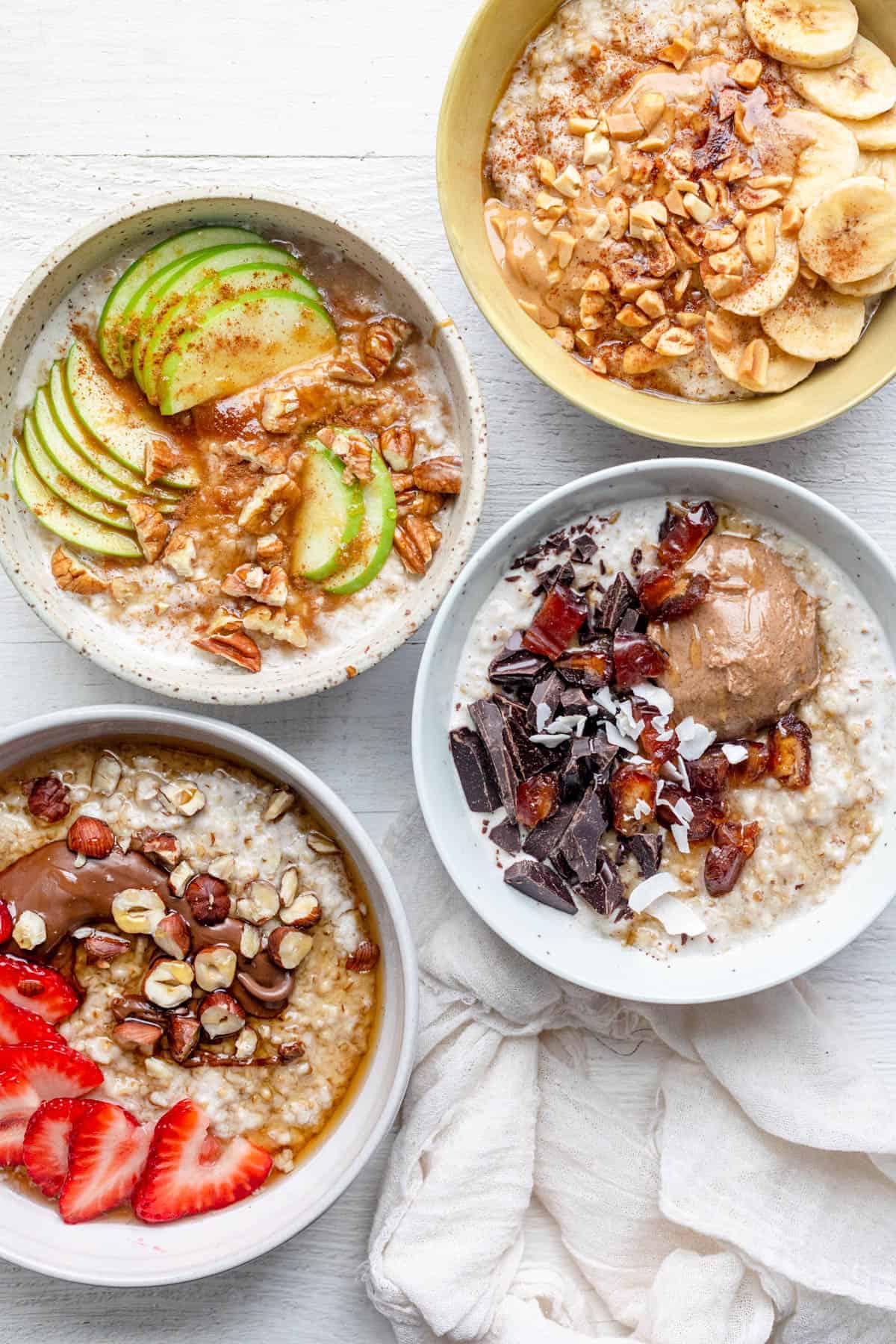 4 varieties of overnight steel cut oatmeal in 4 bowls with different toppings