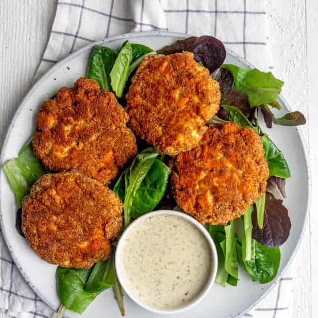 Plate of 4 salmon cakes with mayo dipping sauce