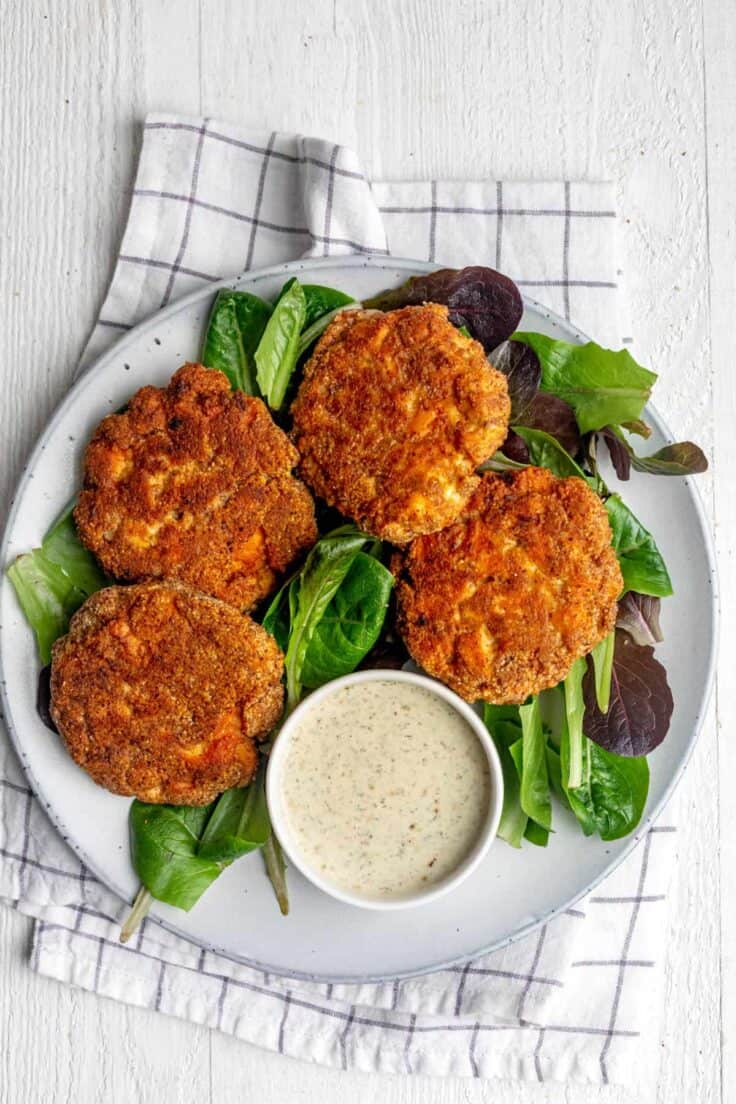 Plate of 4 salmon cakes with mayo dipping sauce