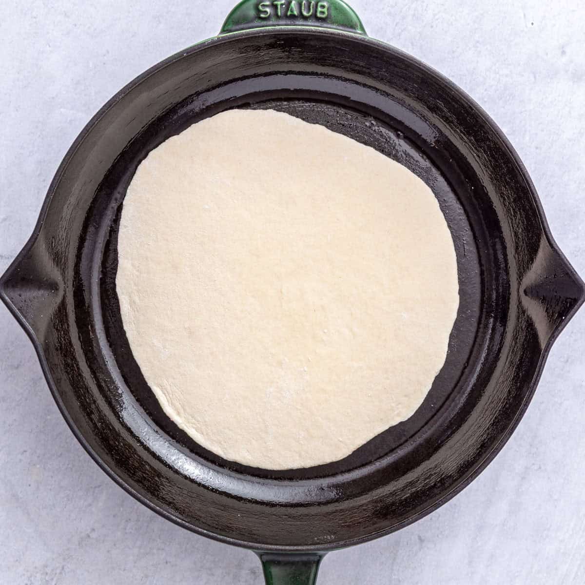 Flatbread in an oiled cast iron skillet.