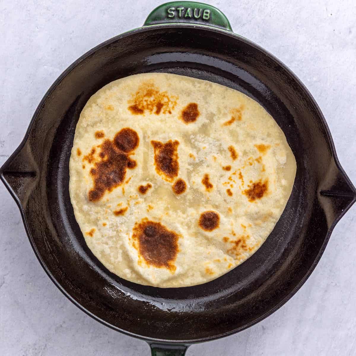 Flatbread After flipping and puffed with golden brown marks.