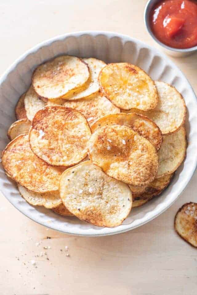 Overhead shot of the oven baked potato chips with ketchup on the side