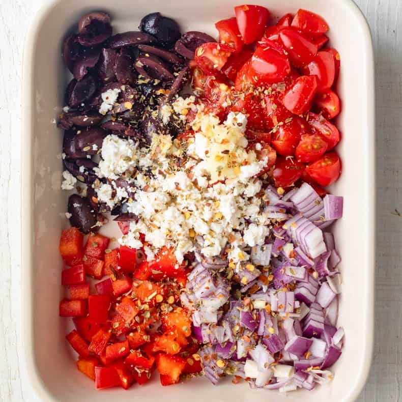 Spices added on top of the veggies and feta.