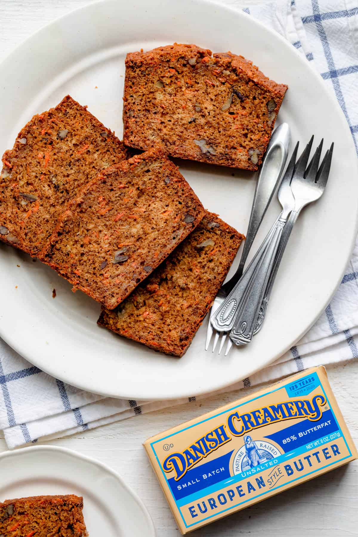 Carrot banana bread served on a plate with Danish Creamery packaging next to it