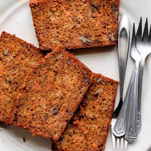 Carrot banana bread on a large white plate with small forks