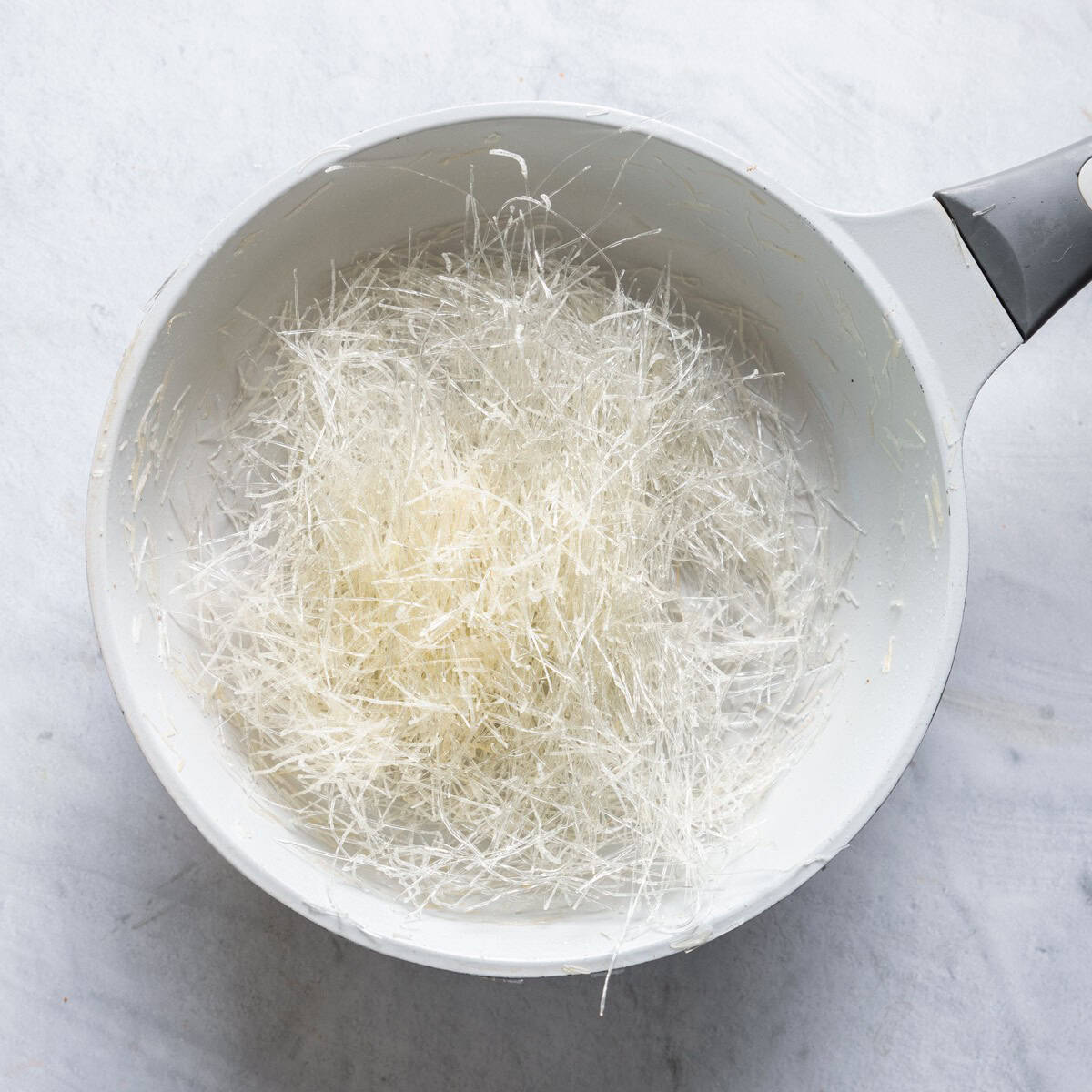 Vermicelli noodles in a pot with a light toast.