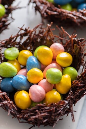Three chocolate nests filled with egg candies.