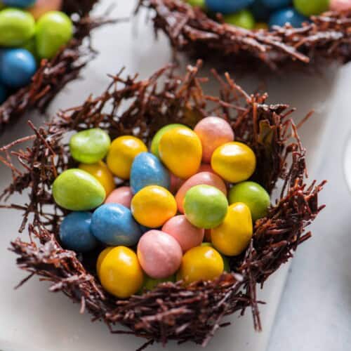 Three chocolate nests filled with egg candies.
