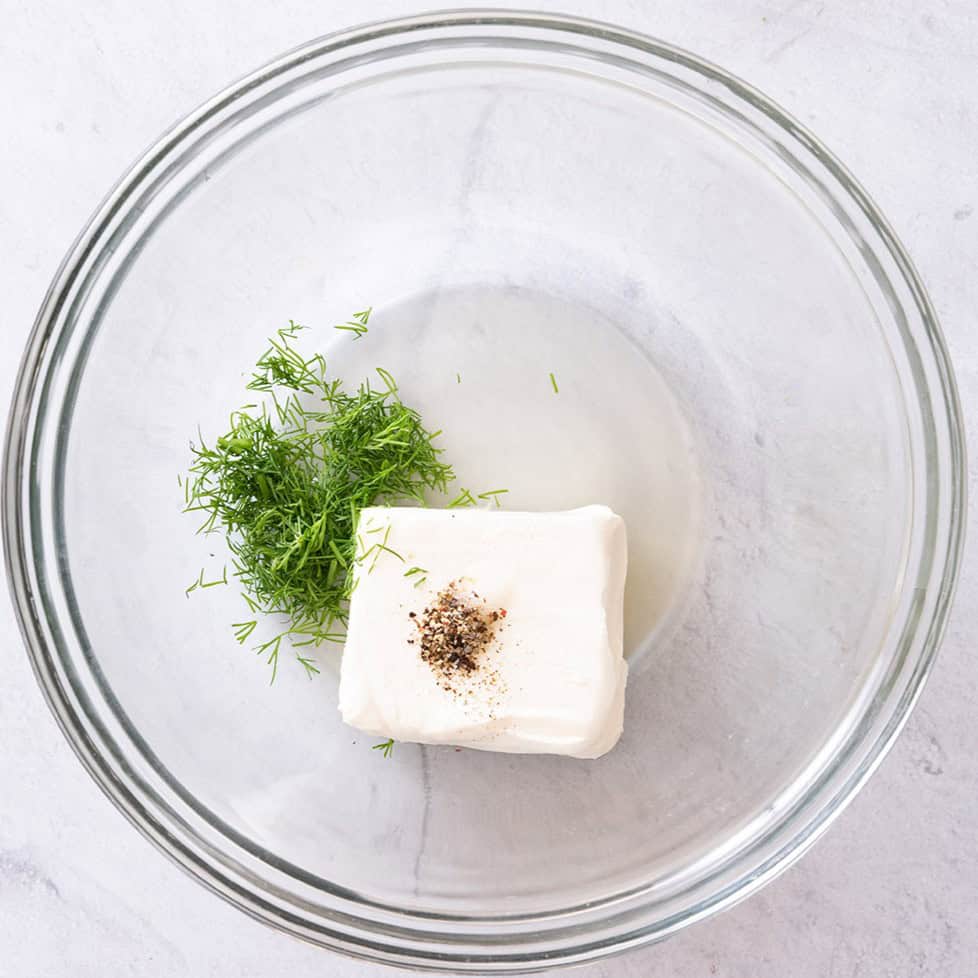 Cream cheese spread ingredients in a bowl before mixing.
