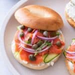 A smoked salmon bagel on a plate.