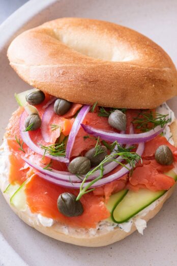 A smoked salmon bagel on a plate.