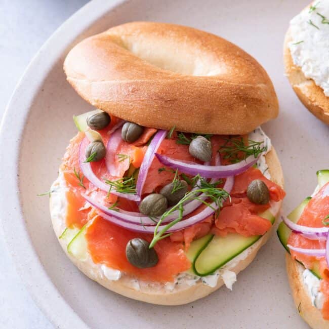 A smoked salmon bagel on a plate.