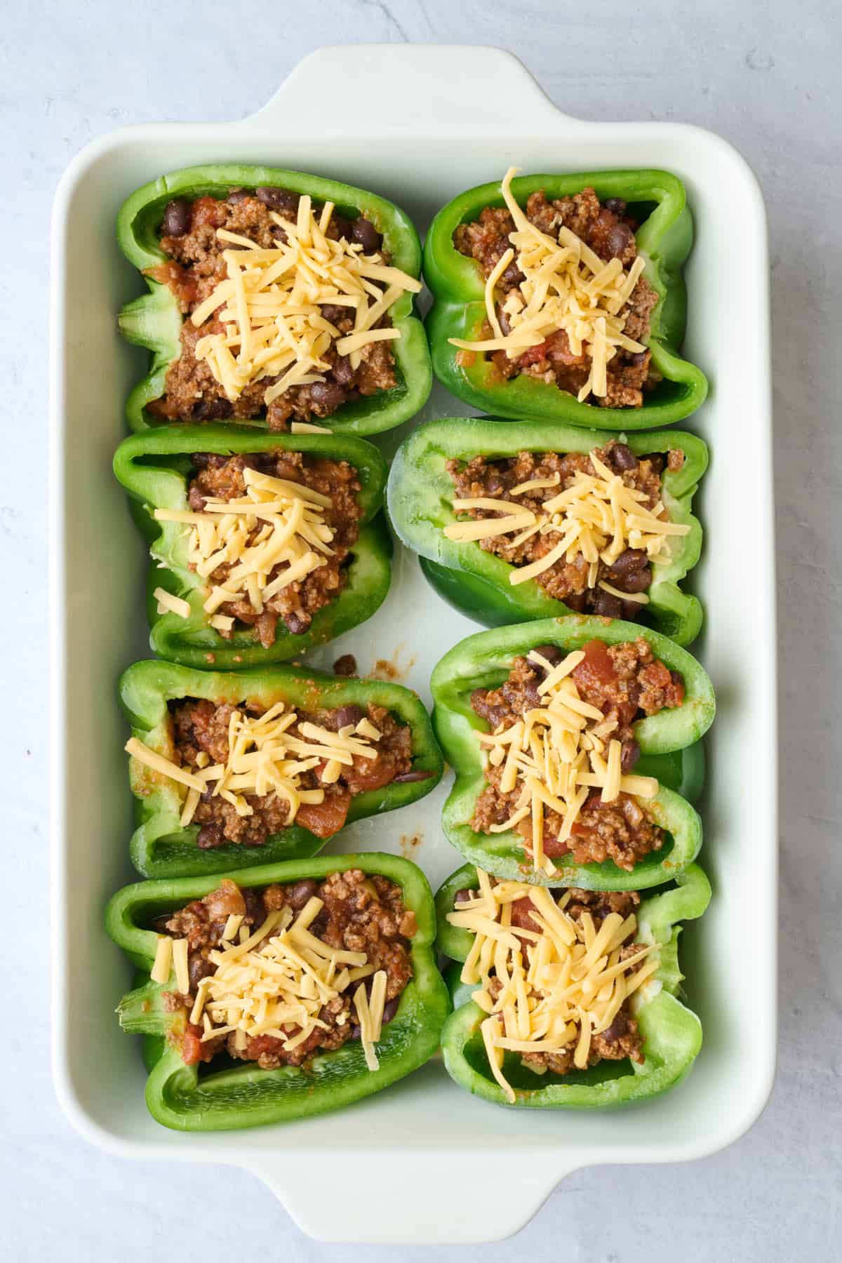 Shredded cheese added on top of each half.