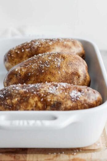 Russel potatoes in a baking dish before baking