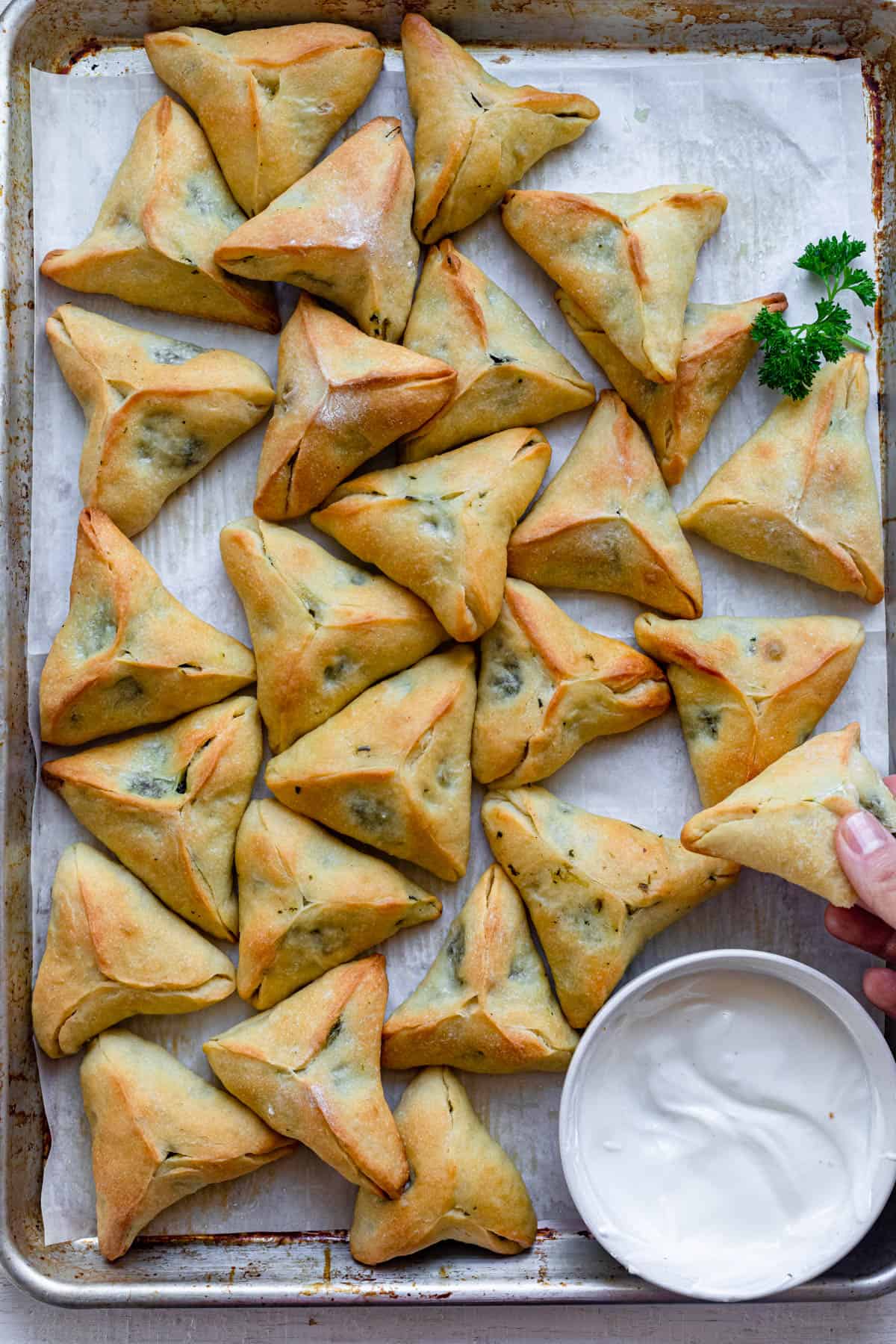 Large tray of spinach fatayer pies served with laban yogurt