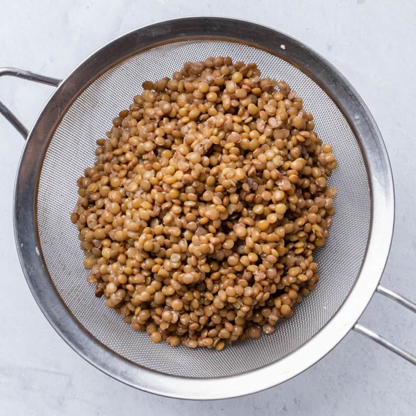 Drained lentils in strainer.