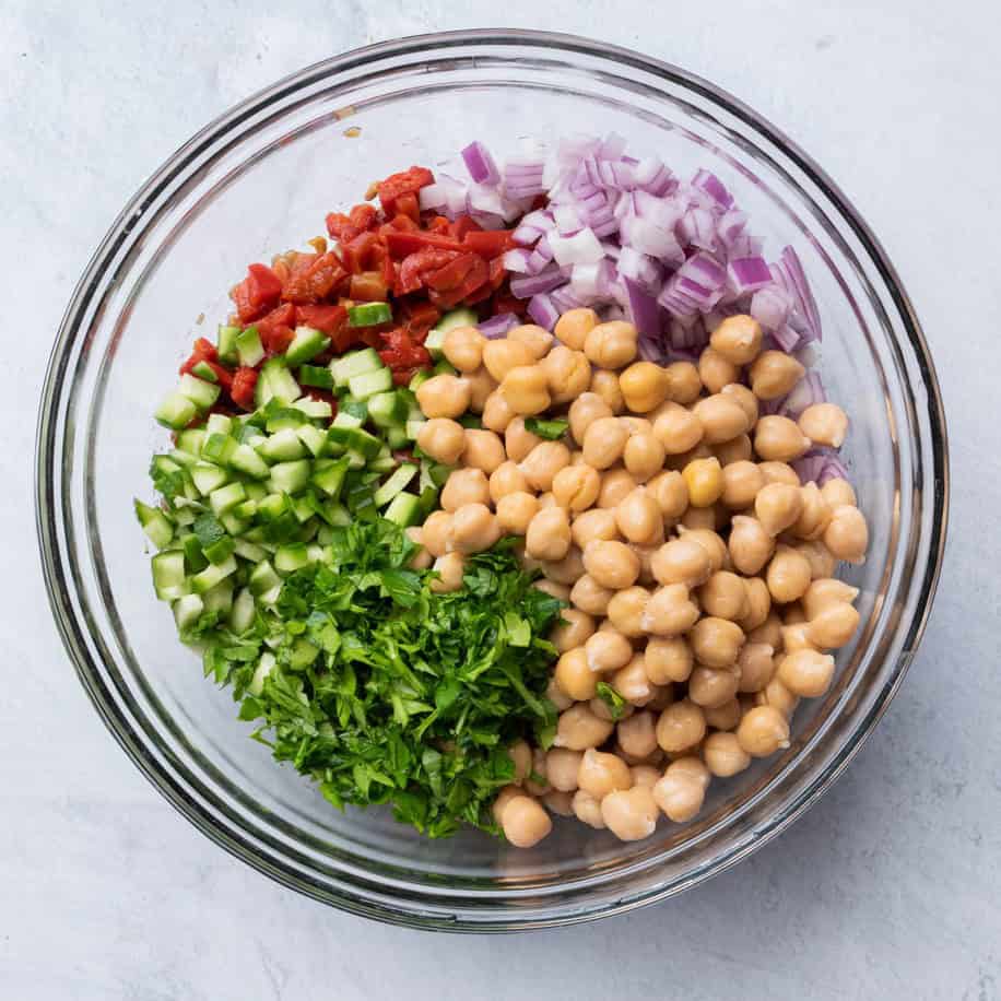 Salad ingredients added in compartments over the lentils.
